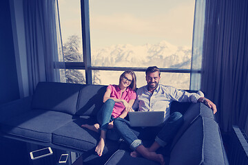 Image showing couple relaxing at  home using laptop computers