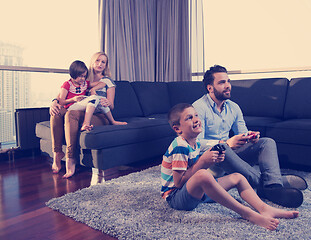 Image showing Happy family playing a video game