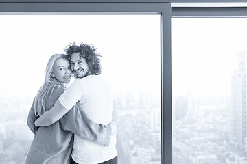 Image showing young couple enjoying morning coffee by the window