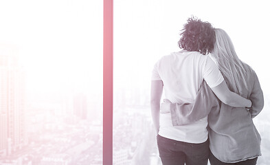 Image showing young couple enjoying morning coffee by the window