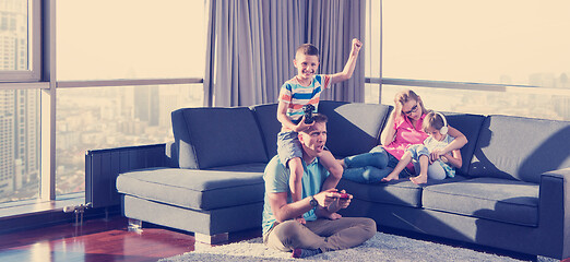 Image showing Happy family playing a video game