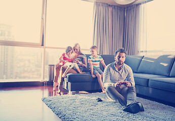 Image showing Happy family playing a video game