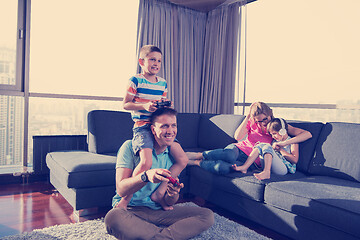 Image showing Happy family playing a video game