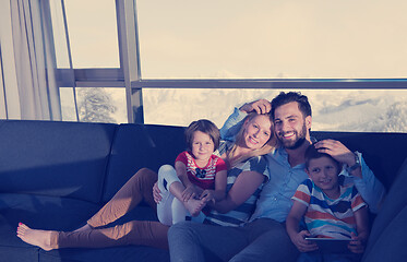 Image showing happy young couple spending time with kids at home