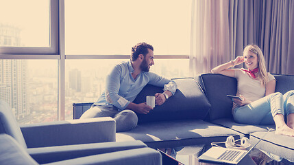 Image showing couple relaxing at  home using tablet computer