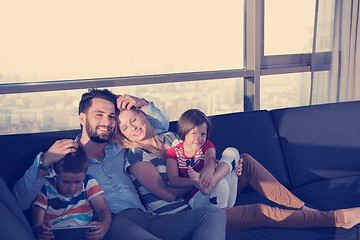 Image showing happy young couple spending time with kids at home