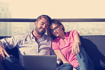 Image showing couple relaxing at  home using laptop computers