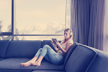 Image showing young girl enjoying music through headphones