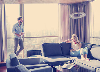 Image showing couple relaxing at  home using tablet computer