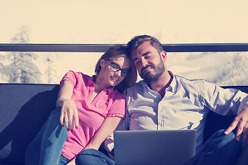 Image showing couple relaxing at  home using laptop computers