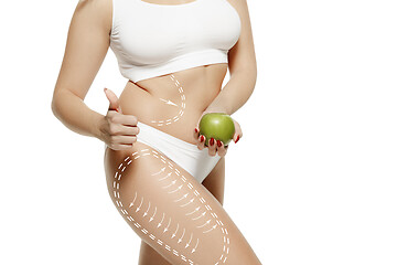 Image showing Female body with the drawing arrows. Fat lose, liposuction and cellulite removal concept