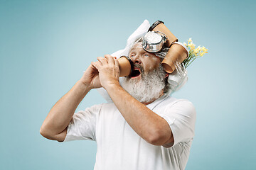 Image showing Tired man sleeping at home having too much work. Bored businessman with pillow and hourglass