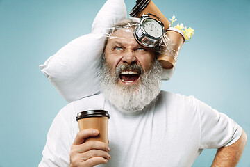 Image showing Tired man sleeping at home having too much work. Bored businessman with pillow and hourglass