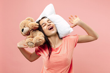 Image showing Tired woman sleeping at home having too much work. Bored businesslady with pillow and toy bear