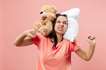 Image showing Tired woman sleeping at home having too much work. Bored businesslady with pillow and toy bear