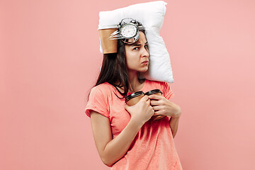 Image showing Tired woman at home having too much work. Bored businesslady with pillow and coffee