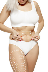 Image showing Female body with the drawing arrows. Fat lose, liposuction and cellulite removal concept