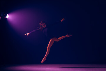 Image showing Young female ballet dancer on neon lights studio background.