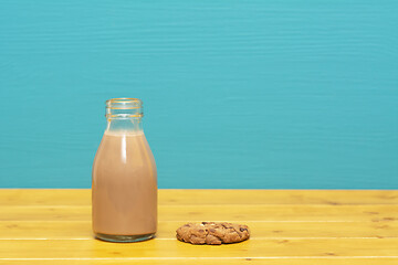 Image showing Chocolate milkshake in a milk bottle and a chocolate chip cookie