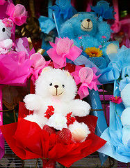 Image showing Cute stuffed toys and flowers.
