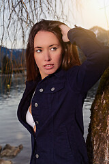 Image showing Portrait of a young brunette woman at the lake