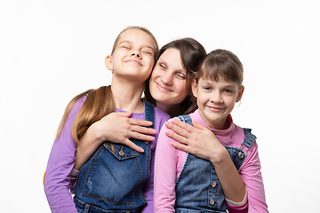 Image showing Mom happily clung to her daughters, isolated on white background