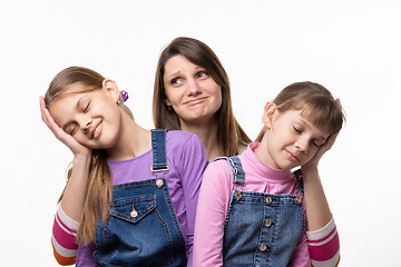 Image showing Mom holds the heads of children on the palms, isolated on a white background