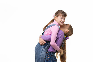 Image showing Girl lifted and hugged another a girl