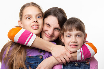 Image showing Mom hugged and squeezed the necks of children, isolated on white background