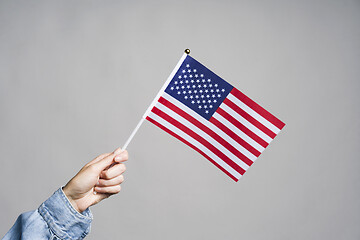 Image showing Human hand holding USA flag