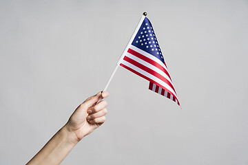 Image showing Human hand holding USA flag