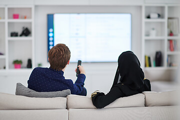 Image showing young muslim couple watching TV together