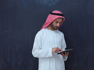 Image showing young arabian muslim businessman using tablet computer