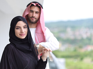 Image showing portrait of beautiful arabian couple standing on balcony