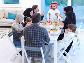 Image showing traditional muslim family praying before iftar dinner