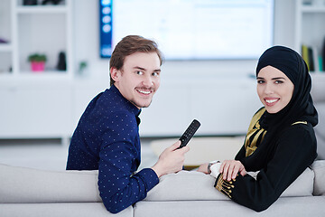 Image showing young muslim couple watching TV together