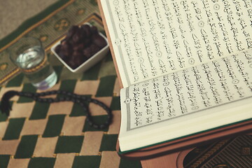 Image showing Iftar time Dried Dates, Holy Quran glass of water and tasbih on 