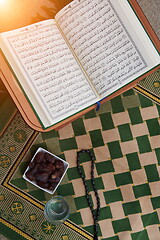 Image showing Iftar time Dried Dates, Holy Quran glass of water and tasbih on 