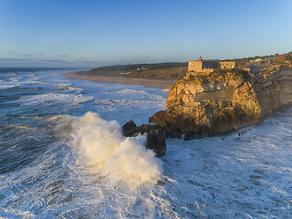 Image showing Lighthouse and big waves at in Nazare