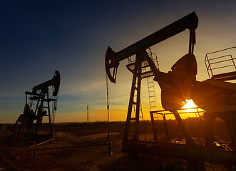 Image showing Two working oil pumps silhouette