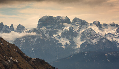 Image showing Snow-capped alps mountains in clouds