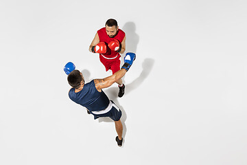 Image showing Two professional boxers boxing isolated on white studio background, action, top view