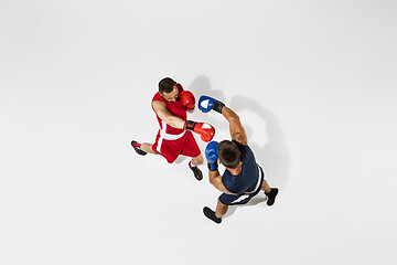 Image showing Two professional boxers boxing isolated on white studio background, action, top view