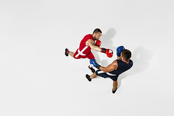 Image showing Two professional boxers boxing isolated on white studio background, action, top view