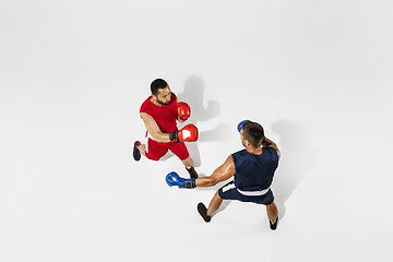 Image showing Two professional boxers boxing isolated on white studio background, action, top view