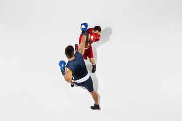 Image showing Two professional boxers boxing isolated on white studio background, action, top view