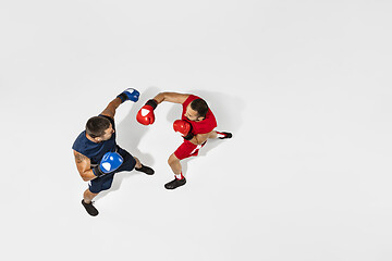 Image showing Two professional boxers boxing isolated on white studio background, action, top view