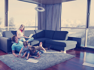 Image showing young couple spending time with kids at home