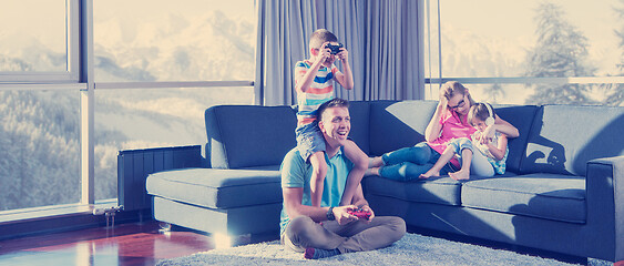 Image showing Happy family playing a video game