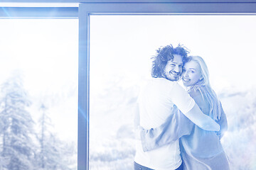 Image showing young couple enjoying morning coffee by the window